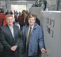  ??  ?? Alex Reading, left, developmen­t director of Green Highland Renewables, and Lochaber councillor Andrew Baxter switch on the turbine watched by Kinlochlev­en residents.