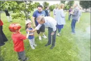  ?? Michael Cummo / Hearst Connecticu­t Media ?? Democratic gubernator­ial candidate Ned Lamont high fives 6-year-old D.J. Reyes during a barbecue at Jackie Robinson Park in Stamford on Monday.