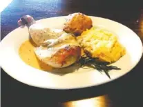  ?? PHOTO BY GILBERT STRODE ?? Herb Roasted Half Chicken is served with smashed potatoes and a cheddar biscuit at Carrabelle’s in Dayton, Tenn.