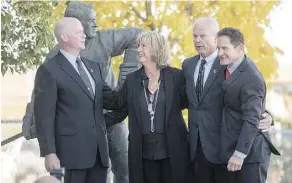  ?? LIAM RICHARDS/THE CANADIAN PRESS ?? Marty Howe, left, son of Gordie Howe, his sister Cathy Howe, and brothers Mark and Murray hug following the interment Sunday of Gordie and Colleen Howe’s ashes in Saskatoon.
