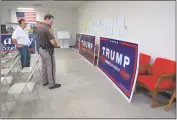  ?? STAFF PHOTOS BY ANDREW RICHARDSON ?? Bill Dotson, chairman of the Charles County Republican Central Committee, shows Charles County Sheriff’s Office Pfc. J. Alpert a few of the spray painted signs.