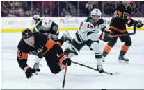  ?? MATT SLOCUM — THE ASSOCIATED PRESS ?? The Flyers’ Owen Tippett, left, collides with Minnesota’s Frederick Gaudreau, rear left, and Jared Spurgeon, right, during the second period on Thursday.