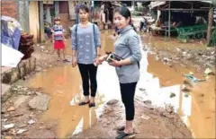  ?? FACEBOOK ?? Battambang’s O’Char Commune Chief Sin Rozeth (front) inspects an area in her commune where she is developing a drainage system, in an image posted to her Facebook page last week.