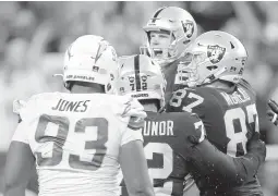  ?? ELLEN SCHMIDT/AP ?? The Raiders’ Daniel Carlson, center, celebrates after his game-winning field goal Sunday night against the Chargers. The Raiders will face the Bengals in the playoffs.