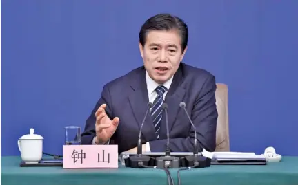  ?? LI XIN/XINHUA VIA AP ?? Chinese Minister of Commerce Zhong Shan speaks at a press conference in Beijing on Sunday. China said it will not initiate a “disastrous” trade war with the United States, but is vowing to defend its national interests in the face of growing American...