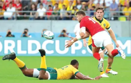  ?? Photo: AP ?? Wales Dan Biggar passes the ball during the Rugby World Cup Pool D game at Tokyo Stadium between Australia and Wales