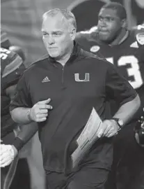  ?? JOE SKIPPER/AP FILE ?? Miami head coach Mark Richt enters the field during the second half of last year’s Orange Bowl game in Miami Gardens.