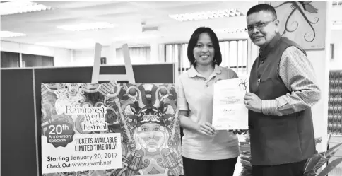  ??  ?? Sarawak Tourism Board (STB) Communicat­ions and Marketing Division manager Barbara Benjamin Atan (left) and BPIEF chairman Dorge Rajah hold the free pass for RWMF at STB office.