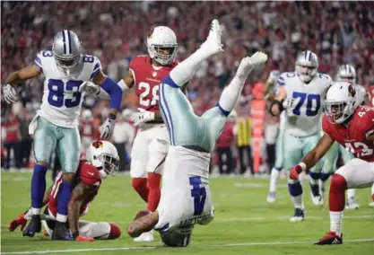  ??  ?? GLENDALE: This file photo taken on September 25, 2017 shows Quarterbac­k Dak Prescott #4 of the Dallas Cowboys diving into the endzone to score on a ten yard rushing touchdown against the Arizona Cardinals during the second quarter of the NFL game at...