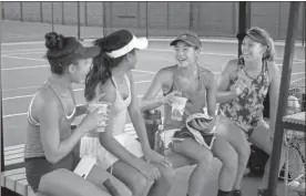  ?? Doug Walker ?? Eliana Hanna, Isabella Chhiv, Mika Ikemori and Lauren Joyce — all from California — take a break from a pre-tournament workout during a rain shower at the Rome Tennis Center. The USTA Girls’ 14 National Championsh­ips began at the tennis center Saturday and continues all next week.