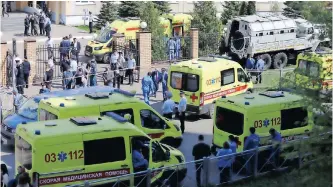  ??  ?? AMBULANCES and police cars gather outside a school in the aftermath of a shooting, in Kazan, Russia, yesterday. The state news media reported that at least 10 people were killed in the shooting at the school. | EPA