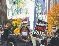  ?? Rebecca Blackwell / Associated Press ?? PENNSYLVAN­IA: Zhanon Morales, 30, rallies for Joe Biden in Philadelph­ia as the Democrat’s supporters call for all votes to be counted in a state that is trending toward Biden.