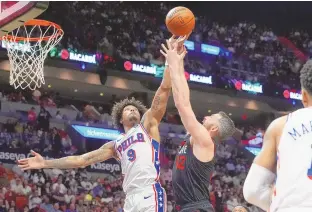  ?? ASSOCIATED PRESS ?? Philadelph­ia 76ers guard Kelly Oubre Jr. (9) and Miami Heat forward Kevin Love (42) go after a rebound during Thursday’s game in Miami.