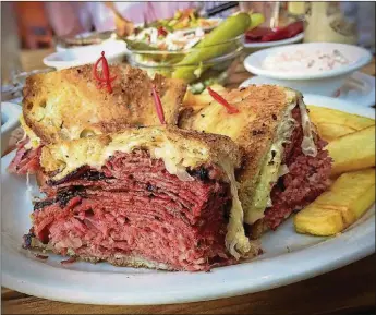  ??  ?? The Combo Reuben has three “halves” to thrill your pastrami and corned beef-loving heart.