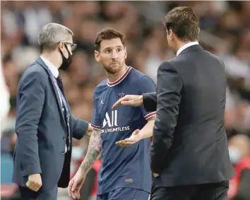  ?? — Reuters ?? Paris St Germain coach Mauricio Pochettino with Lionel Messi as he is subsituted.