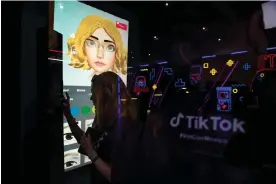  ?? Photograph: Claudio Cruz/AFP/Getty Images ?? A young woman makes a virtual image of herself at a TikTok stand during Vidcon in Mexico City.