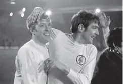  ??  ?? 0 Norman Hunter (right) and Mick Jones celebrate wrapping up the 1969 League Championsh­ip with a 0-0 draw at Liverpool