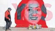  ?? [NIALL CARSON/PA VIA AP] ?? A man walks past a mural showing Savita Halappanav­ar, a 31-year-old Indian dentist who had sought and been denied an abortion before she died after a miscarriag­e in a Galway hospital, with the word YES over it, in Dublin, Ireland, on the day of a...