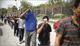  ?? EMILIO ESPEJEL / AP ?? Migrants return to Mexico, using the Puerta Mexico bridge that crosses the Rio Grande river, in Matamoros, Mexico, on Wednesday on the border with Brownsvill­e, Texas. The United States government has sent some 800 mostly Central American and Cuban immigrants back to this northern Mexico border city since expanding its controvers­ial plan to this easternmos­t point on the shared border two weeks ago.