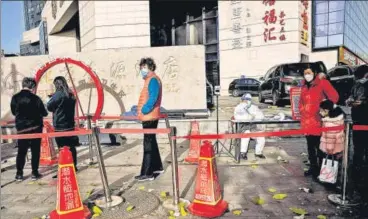  ?? AFP ?? People queue up for a swab test for Covid-19 at a collection site in Beijing on Friday.