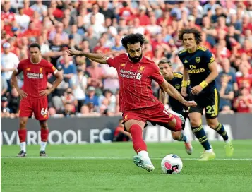  ?? AP ?? Liverpool’s Mohamed Salah scores from the penalty spot. It was the first of his two goals in the 3-1 win over Arsenal.