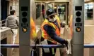  ??  ?? An MTA worker cleans turnstiles at the Times Square subway station. Photograph: Jeenah Moon/Reuters