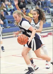  ?? / Scott Herpst ?? Gordon Lee’s Dallas Wagoner gets past Heritage’s Aaliyah Rodgers during last week’s NGAC girls’ game in Boynton. The Lady Generals held on for a 32-25 victory.