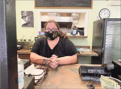  ?? Mary E. O'Leary/Hearst Connecticu­t Media ?? Above, Erin Collins inside Crafted By Hand restaurant at 167 Orange St., New Haven. At right, Carl “Ed” Plummer and Proeyah Benton inside the “Green Machine” food truck for Vegan Ahaya.