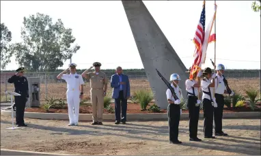  ?? RECORDER PHOTO BY ALEXIS ESPINOZA ?? PMA Honor Guard cadets Gutierrez, Barnhart, Hernandez and Williams, present the colors at the dedication ceremony of the A4 Skyhawk at the Portervill­e Municipal Airport on Tuesday morning. Saluting the flag, from left to right, is Portervill­e Police Chief Eric Kroutil, Master Chief Dave Conduff, Lemoore NAS Captain Jim Bates and honoree Everett Alvarez.