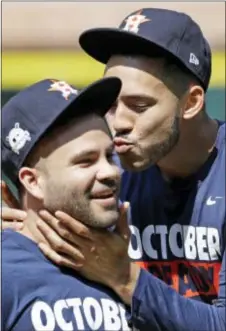  ?? DAVID J. PHILLIP — THE ASSOCIATED PRESS ?? Houston shortstop Carlos Correa, right, jokes with second baseman Jose Altuve during practice Wednesday in