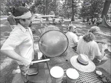  ?? NWA Democrat-Gazette/J.T. WAMPLER ?? Matt Kennedy (left) drums Sunday along with Shane Morris (right) and Barry More at Wilson Park in Fayettevil­le. The group of friends and like-minded strangers hope to start a drum session the first Sunday of the month.