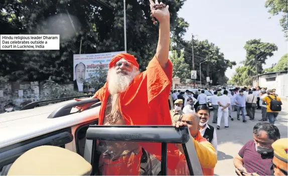 ??  ?? Hindu religious leader Dharam Das celebrates outside a court in Lucknow, India