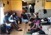  ?? ELLIOT SPAGAT — THE ASSOCIATED PRESS FILE ?? Cameroonia­ns wait in an apartment in Tijuana, Mexico, until their names are called to claim asylum in the U.S.