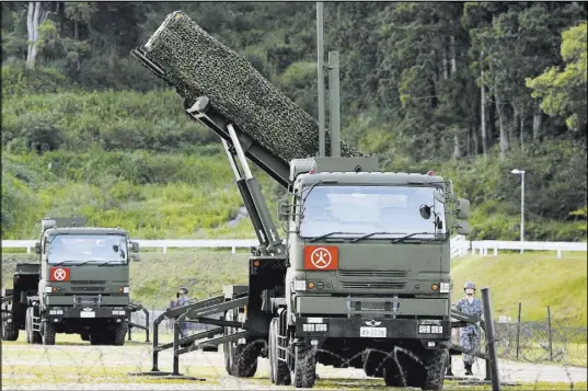  ?? Ryosuke Ozawa The Associated Press ?? A PAC-3 intercepto­r is deployed in the compound of the Japan Ground Self-Defense Force on Saturday in Konan, Kochi prefecture, Japan. Japan started deploying intercepto­rs after North Korea threatened to send ballistic missiles toward Guam.