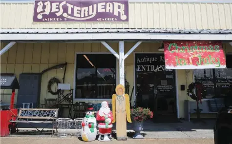  ?? STAFF PHOTO BY ERIN O. SMITH ?? Yesteryear Antiques is nearing the end of its fourth annual Christmas in July sale. They’ll serve refreshmen­ts and give away door prizes Saturday.