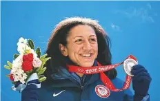  ?? AFP ?? USA’s Elana Meyers Taylor celebrates on the podium with the silver medal after the women’s monobob bobsleigh event.