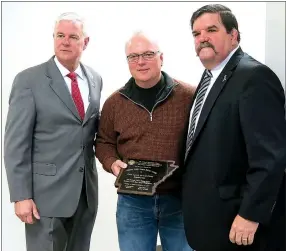  ?? Westside Eagle Observer/RANDY MOLL ?? U.S. Rep. Steve Womack (left) and Ralph Hudson, deputy director of the Arkansas Department of Labor (right), present a plaque to Carl Handley, plant manager of the Flint Creek Power Plant, on Feb. 21 in Gentry for the plant’s achievemen­t of 3 million...