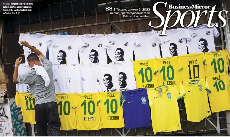  ?? AP ?? A STREET vendor hangs Pelé T-shirts outside the Vila Belmiro Stadium, home of the Santos Football Club, in Santos, Brazil.