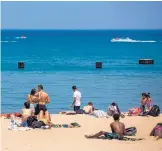  ?? BRIAN CASSELLA/CHICAGO TRIBUNE ?? People enjoy the hot weather Beach in Chicago. at North Avenue