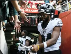  ?? MARK TENALLY - AP ?? Philadelph­ia Eagles wide receiver Greg Ward (foreground) signs autographs after last Sunday’s win against the Washington Football Team in Landover, Md.