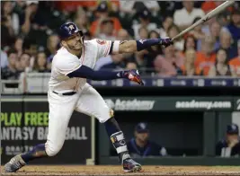  ?? David J. Phillip ?? The Associated Press Houston Astros shortstop Carlos Correa strikes out swinging against the Tampa Bay Rays during the eighth inning on Tuesday in Houston.