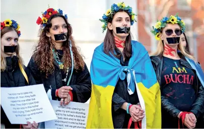  ?? ?? Women, silenced by tape over their mouths, protest sexual abuse by Russian soldiers in Ukraine, in New York (AFP)