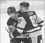  ?? Associated Press photo ?? Pittsburgh Penguins' Sidney Crosby (87) celebrates with Kris Letang (58) after Crosby assisted on a goal for the 1,000th point of his NHL career, during the first period of an NHL hockey game against the Winnipeg Jets in Pittsburgh, Feb. 16. Chasing a...