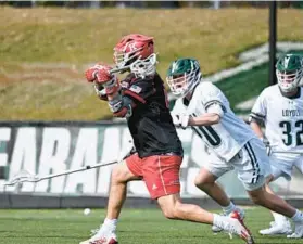  ?? CRAIG CHASE/LOYOLA ATHLETICS ?? Rutgers’ Colin Kurduyla scores on a shot in the first half as Loyola Maryland’s Will Sherwood and Jacob Sullivan defend Saturday at Ridley Athletic Complex.