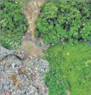  ?? AFP/FILE ?? A flock of birds fly over plastic waste at a collection site in Alue Lim village in Lhokseumaw­e, Indonesia.