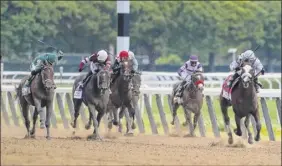  ?? Seth Wenig / Associated Press ?? Tiz the Law, right, with jockey Manny Franco, is the clear favorite to win the Kentucky Derby on Sept. 5 after winning the Belmont Stakes on June 20.