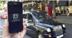  ?? — Reuters ?? An Uber app logo is displayed on a mobile telephone, as it is held up for a posed photograph in central London, Britain.