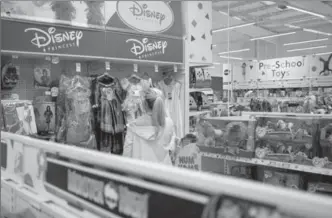  ?? LEON NEAL, GETTY IMAGES ?? A woman looks at Disney merchandis­e in a Toys "R" Us store in Luton, England.