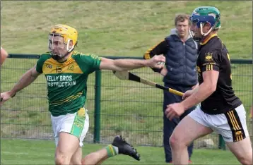  ??  ?? Peter Atkinson of HWH-Bunclody shakes off P.J. Carroll (Adamstown) in the Group B clash in Bellefield.