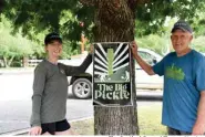  ?? The Sentinel-Record/Tanner Newton ?? ■ Kate Tully, left, and David Tappe show off a poster for The Big Pickle, a pickleball festival, at Garland County Veterans Memorial and Military Park.